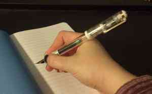 Pen in my hand with the cap on the back.
