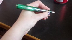 Writing with pen cap on the back. 