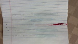 Reverse of normal notebook paper of ink swabs to the left