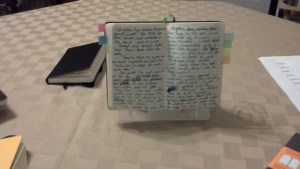 With A notebook propped up. So much easier to transcribe this way.