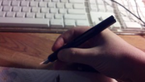 Pen without cap in hand.