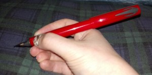 Pen with cap in hand