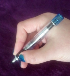 Pen in hand without cap.