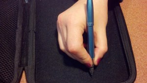 Pen in hand with cap